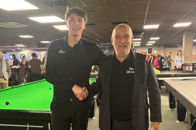 Champion Ben Mertens shakes hands with tournament official Gery De Mol.